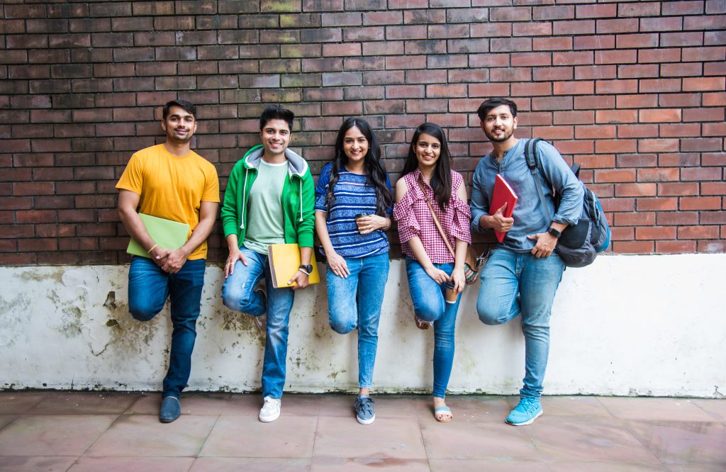 Education is fun - Cheerful Pakistani asian young students enjoying togetherness in college campus